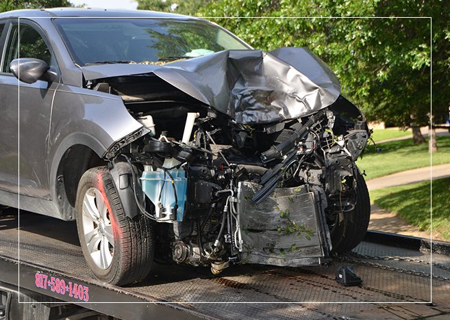 A car that has been wrecked on the side of the road.