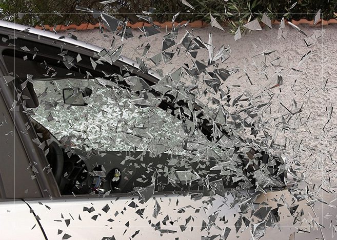 A car that has been smashed by a shattered windshield.