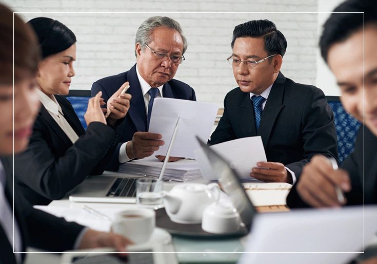 A group of people sitting around a table.