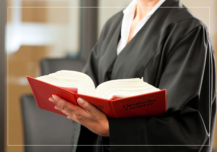 A judge holding an open book in her hands.