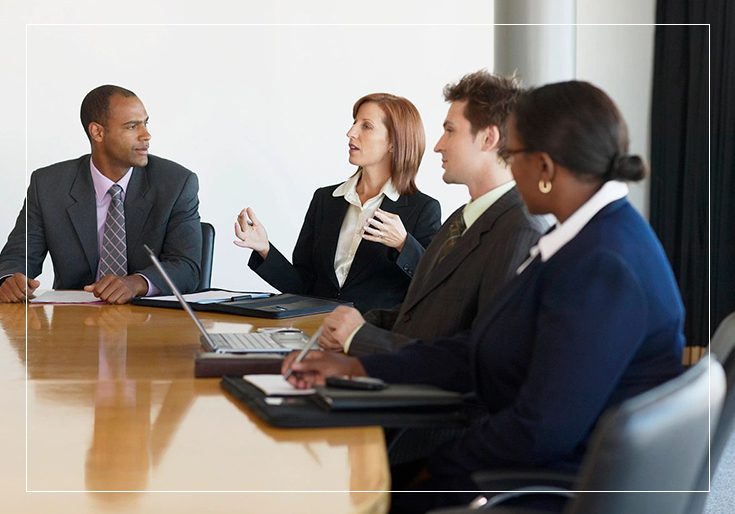 A group of people sitting at a table talking.