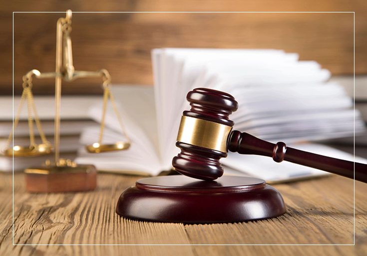 A wooden gavel sitting on top of a table.