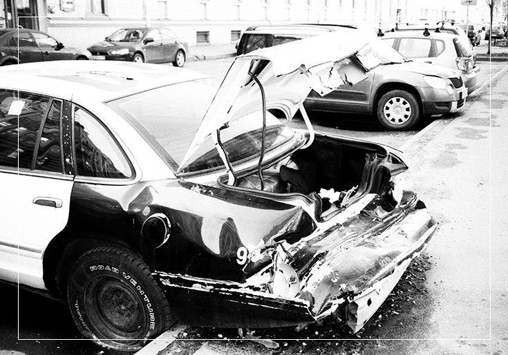 A black and white photo of cars that have been hit by an accident.