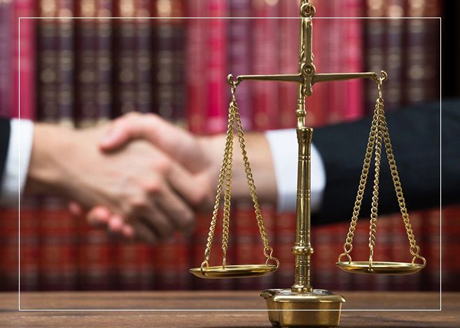 A judge 's gavel and scale on top of a table.