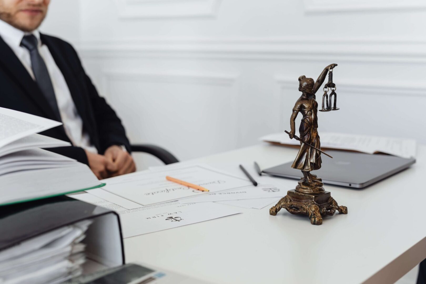 A statue of lady justice on top of a desk.