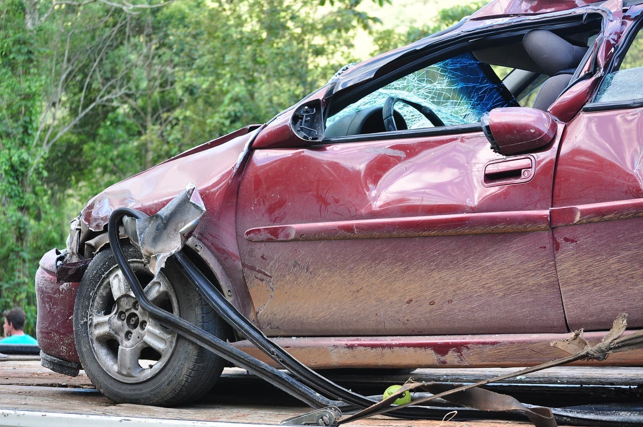 A car that has been smashed in the road.